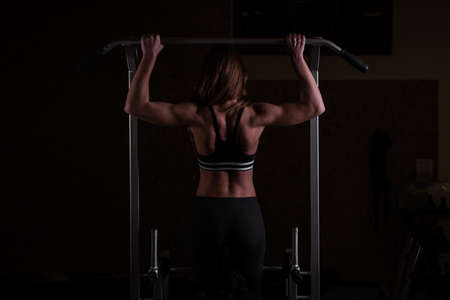 Back of athletic girl. gym concept. muscular fitness woman, trained female body.healthy lifestyleの写真素材