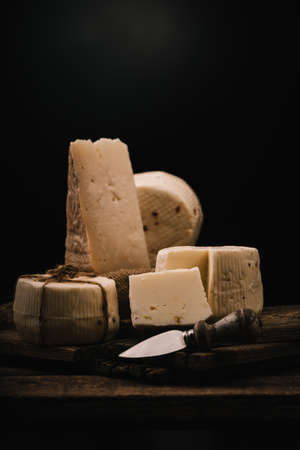 Sicilians cheeses on a black background with a place for text. Close up