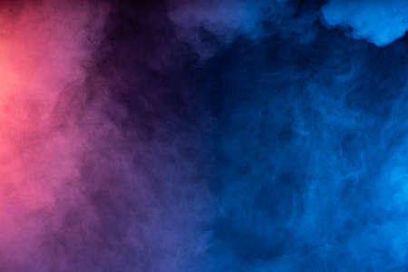 Black background with smoke colors. Cloud of smoke with different colorsの写真素材