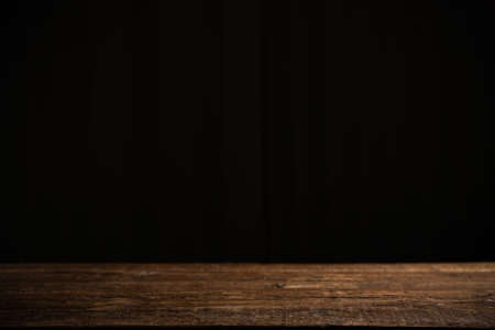 Empty wooden table on a black backgroundの写真素材