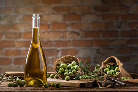 Olives and olive oil in a bottles close upの写真素材