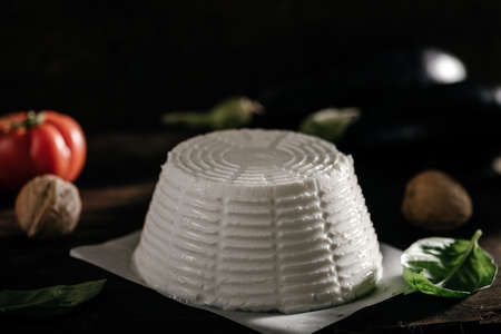 Fresh ricotta cheese on wooden background close upの写真素材