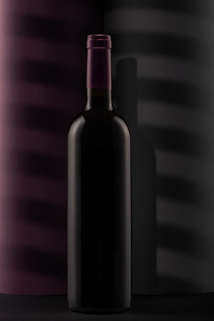 Bottle of red wine on a black backgroundの写真素材
