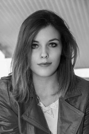 Breathtaking model posing at fuel pump in different outfitsの写真素材