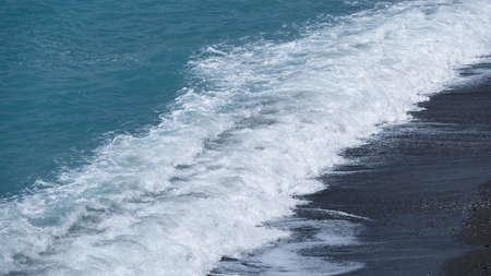 Camogli, Genoa, Liguria / Italy - June 12 2019: Ligurian sea waves of the beach in Camogli