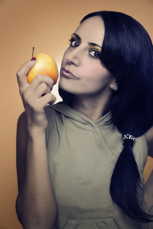 Sexy woman kissing an appleの写真素材
