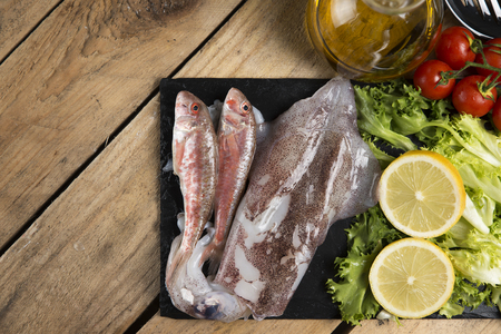 Fresh squid and red mullet fish served on a slate plate