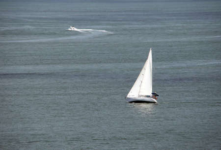sail boat navigating the blue oceanの写真素材