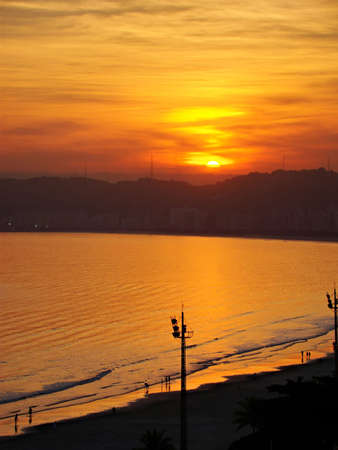 beautiful golden sunset and view of the beach at the city of santos in brazilの写真素材