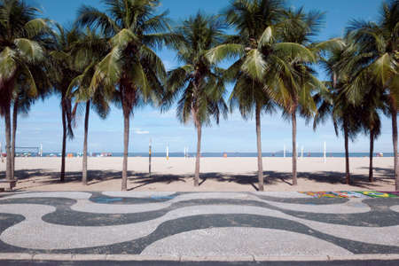 Copacabana beach view with mosaic sidewalk and palm treesの写真素材