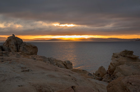 Sunset over the sea in Sarakiniko, Milos, Greeceの写真素材