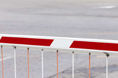 a striped barrier preventing access to vehicles