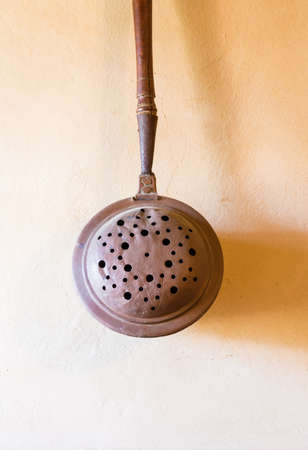 antique copper ladle in the kitchen of a castleの写真素材