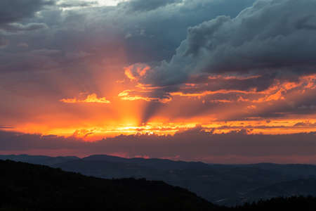 dark clouds in the mountains during sunsetの写真素材