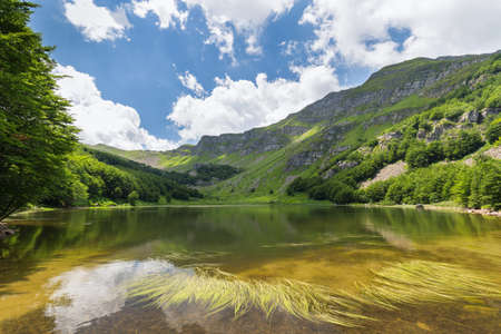 white clouds are reflected in mountain lakeの写真素材