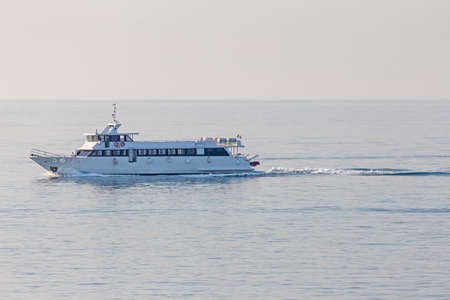 great boat for sightseeing tour floats through the waters of the seaの写真素材