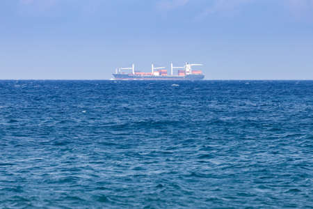 freight ship on the horizon of the seaの写真素材