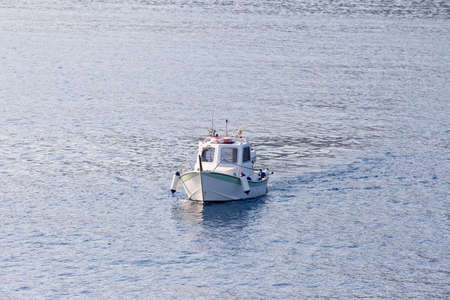 small fishing boat sailing in the seaの写真素材