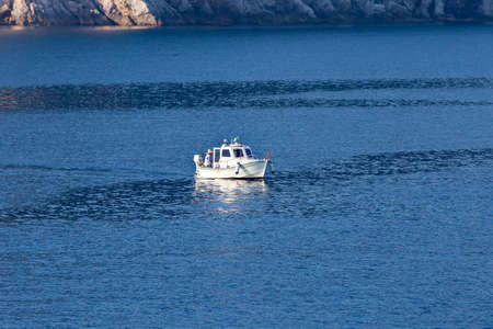 fisherman on a small fishing boatの写真素材