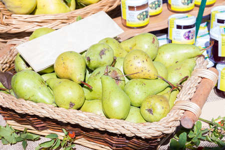 basket of pears for sale at the marketの写真素材