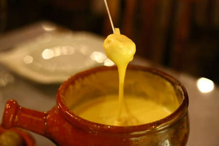 Cheese fondue with bread, delicious typical European foodの写真素材
