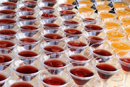 Group of cocktails martini glasses. Yellow and red drinks.