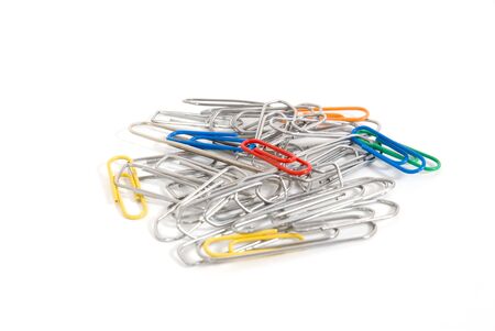 Heap of colored paper clips and silver on white backgroundの写真素材