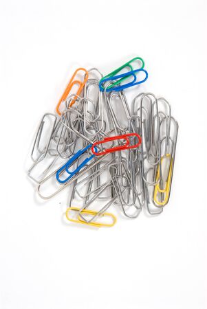 Heap of colored paper clips and silver on white backgroundの写真素材