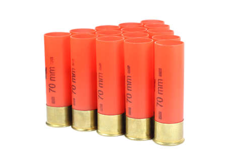 Red casings from a shotgun on a white background