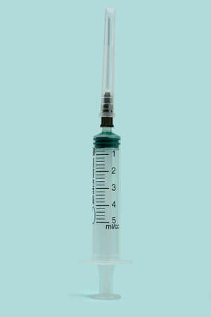Medical syringe for drugs isolated on a blue backgroundの写真素材