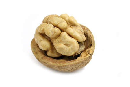 Chopped walnut halves on white backgroundの写真素材