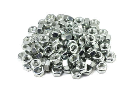 A handful of metal nuts on a white backgroundの写真素材