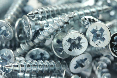 Several brilliant construction screws closeupの写真素材