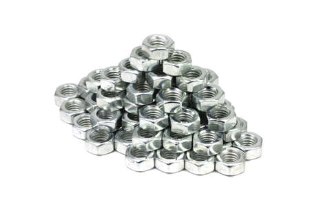 Metal nuts laid pyramid on a white backgroundの写真素材