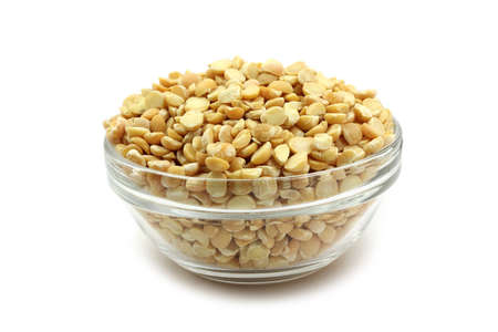 Grains of dried peas in a glass container on white backgroundの写真素材