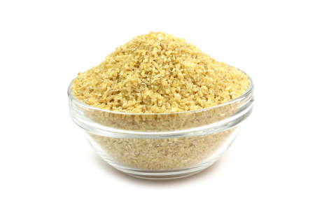Grind grain corn in a glass container on white backgroundの写真素材