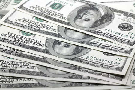 Hundred dollar bills spread out pile backgroundの写真素材