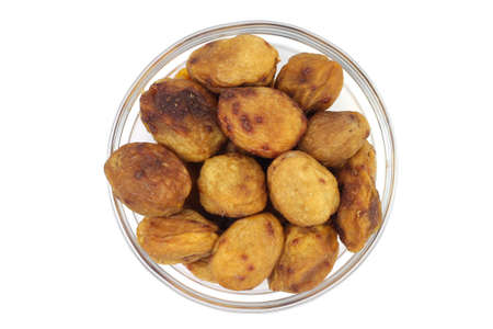 Dried apricots in a glass isolated on white background の写真素材
