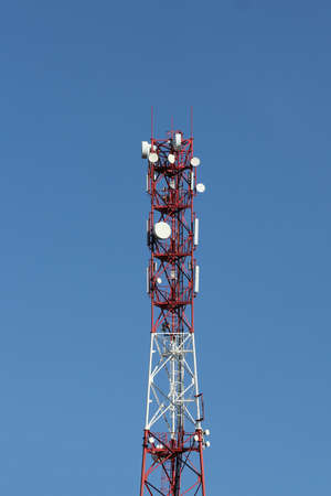 Tower with electronic equipment against the blue sky