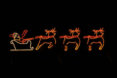 Father Christmas taking off from a rooftop in his sleigh!の写真素材