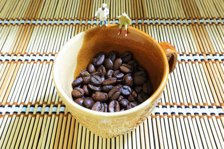 Little men on the cup of coffee beans.の写真素材