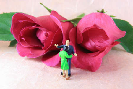Little couple is celebrating with the roses.の写真素材