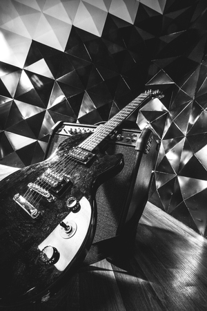 electric guitar and classic amplifier on a dark background