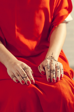 Red manicured hands with Mehndiの写真素材