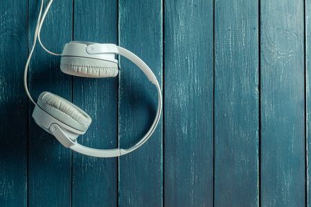 Modern portable audio earphones on wood boardの写真素材