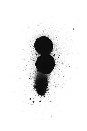 Black color spray paint on a white background paperの写真素材