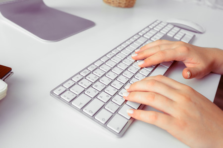 Hands of an office woman typingの写真素材
