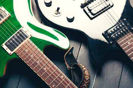 Electric guitar body and neck detail on wooden backgroundの写真素材
