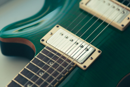 Electric guitar body and neck detail on wooden backgroundの写真素材