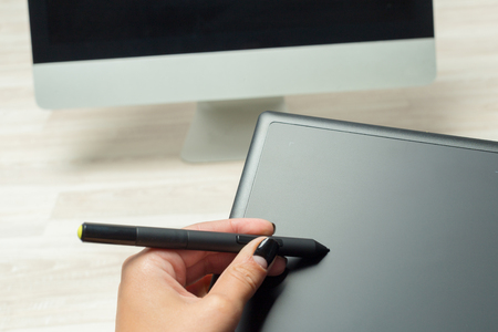 Hand of graphic designer working with stilus and tabletの写真素材